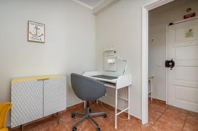 a room with a desk and a chair and a door at Lovely beach apartment, sea views, rooftop terrace #1974 in Budens