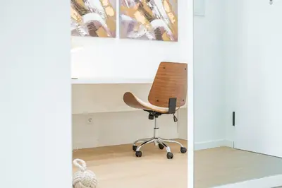 an office chair sits in a corner of a room at Nora Charming Apartment - Pool -10m Walk City Center in Funchal