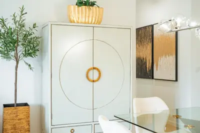 a white cabinet in a dining room with a glass table at Nora Charming Apartment - Pool -10m Walk City Center in Funchal