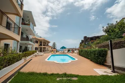 a swimming pool in a courtyard of a building at Nora Charming Apartment - Pool -10m Walk City Center in Funchal