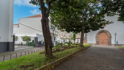 a street with trees and a building with a wooden door at Machico Village by LovelyStay in Machico