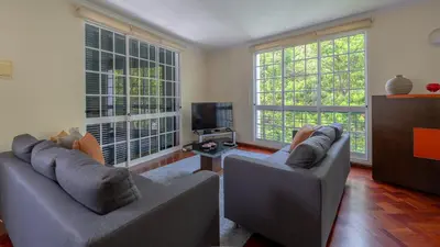 a living room with two couches and a tv at Machico Village by LovelyStay in Machico