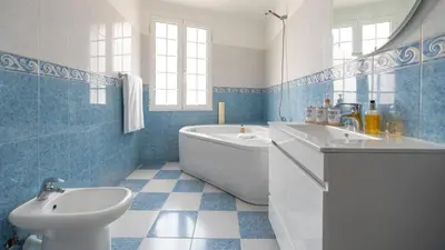 a bathroom with a tub and a sink and a toilet at Machico Village by LovelyStay in Machico