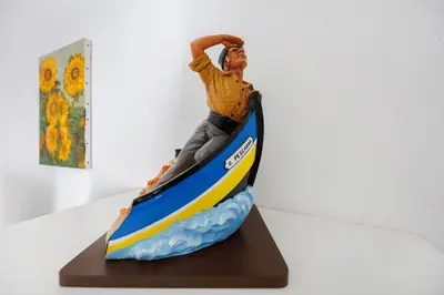 a figurine of a man riding a wave on a surfboard at Apartamento Carrapateira in Bordeira
