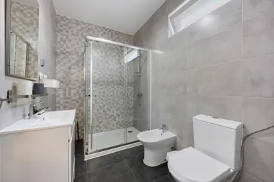 a bathroom with a toilet and a sink and a shower at Apartamento Carrapateira in Bordeira