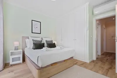 a white bedroom with a large bed with white sheets at Achada by Homie in Funchal