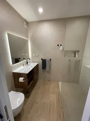 a bathroom with a white toilet and a sink at luz beach home in Luz