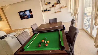 a living room with a pool table and a couch at luz beach home in Luz