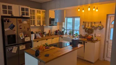 a kitchen with a refrigerator freezer and a counter top at luz beach home in Luz