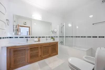 a bathroom with a sink and a tub and a toilet at Villa Ruby in Budens