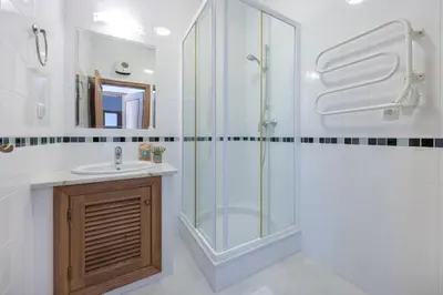 a bathroom with a glass shower and a sink at Villa Ruby in Budens