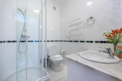 a bathroom with a shower and a sink and a toilet at Villa Ruby in Budens