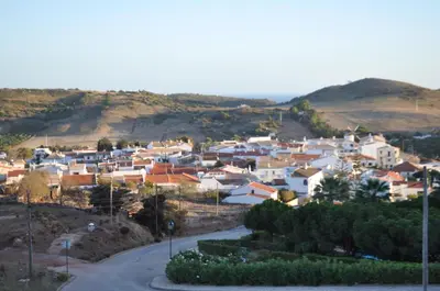 a village with white houses on a hill at Villa Ruby in Budens