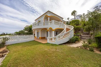 a large white house with a large yard at Villa Ruby in Budens