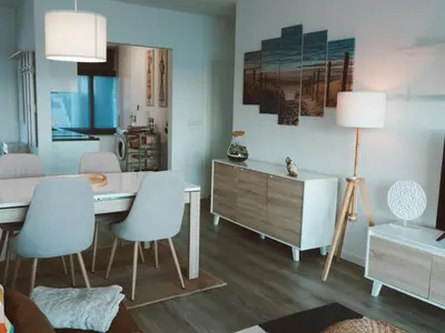 a dining room with a table and chairs and a mirror at Madeira Home at Cliff Residence in Santa Cruz