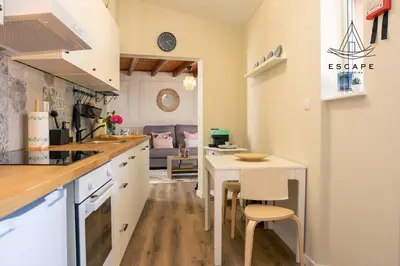 a kitchen with a table and a dining room at Izzys Place by ESCAPE to Madeira in Ponta do Sol