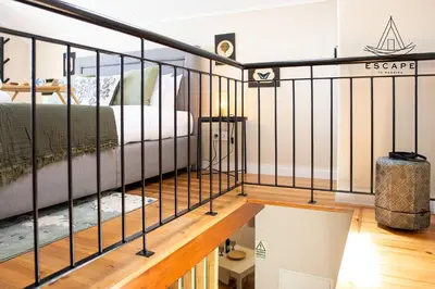 a bedroom with black railings and a bed at Izzys Place by ESCAPE to Madeira in Ponta do Sol