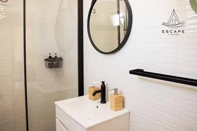 a bathroom with a sink and a mirror at Izzys Place by ESCAPE to Madeira in Ponta do Sol