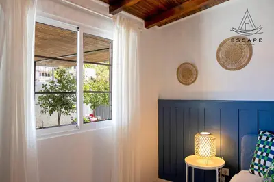 a room with a window and a table with a lamp at Izzys Place by ESCAPE to Madeira in Ponta do Sol