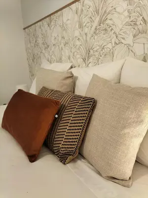 a white bed with pillows on it with a wallpaper at Casa Solar do Tristão in Santa Maria Madalena