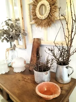 a table with two vases and a mirror and flowers at Casa Solar do Tristão in Santa Maria Madalena