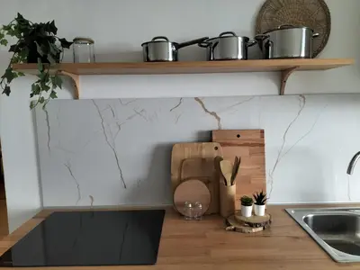 a kitchen with a counter with pots and pans on a shelf at Casa Solar do Tristão in Santa Maria Madalena