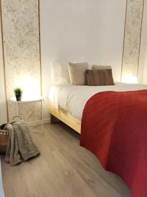 a bedroom with a bed with two lamps on it at Casa Solar do Tristão in Santa Maria Madalena