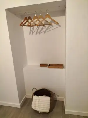 a closet with wooden hangers and a basket at Casa Solar do Tristão in Santa Maria Madalena