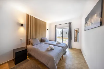 a bedroom with two beds and a window at Sagres ZEN - 3 Bedroom House in Sagres