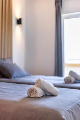 a towel on a bed in a hotel room at Sagres ZEN - 3 Bedroom House in Sagres