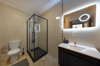 a bathroom with a shower and a toilet and a sink at Sagres ZEN - 3 Bedroom House in Sagres