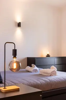 a bedroom with a bed with towels on it at Sagres ZEN - 3 Bedroom House in Sagres