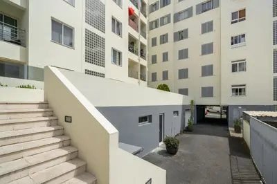 an alleyway between two buildings with stairs at OurMadeira - Madalena Living Apt in Funchal
