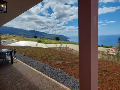 a view from the porch of a house with a table at Casa Caipirinha in Prazeres
