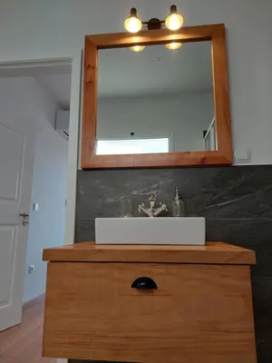 a bathroom with a sink and a mirror on a dresser at Casa Caipirinha in Prazeres