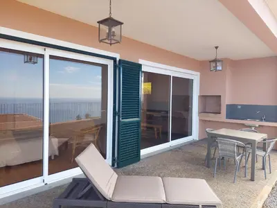 a living room with a view of the ocean at Casa Caipirinha in Prazeres