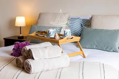 a bedroom with a bed with a table on it at La Maison by Escape to Madeira in Ponta do Sol