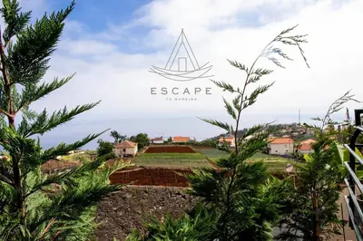 a view of a farm with a boat on the horizon at La Maison by Escape to Madeira in Ponta do Sol