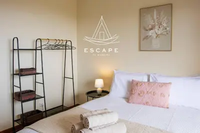 a bedroom with a white bed and a sign on the wall at La Maison by Escape to Madeira in Ponta do Sol