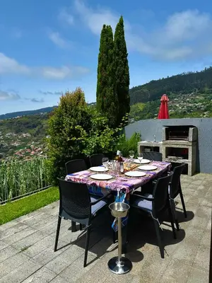 a table and chairs on a patio with a view at Sunset Dreams - Arco da Calheta in Arco da Calheta