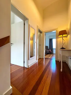 an empty living room with a hard wood floor at Sunset Dreams - Arco da Calheta in Arco da Calheta