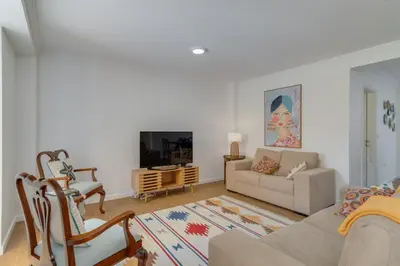 a living room with a couch and a tv at Maria Madalena in Madalena do Mar