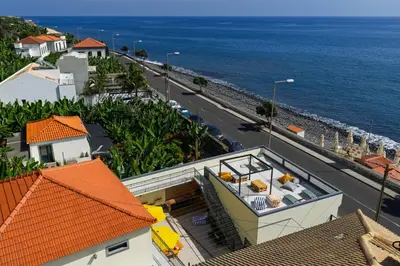 an aerial view of a house and the ocean at Maria Madalena in Madalena do Mar