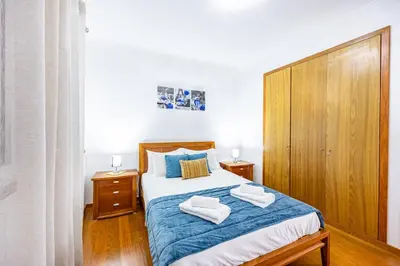 a bedroom with a bed with two towels on it at Pérola Apartments by YOUR KEY in Caniço