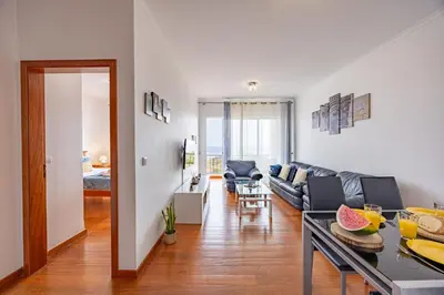 a living room with a couch and a table at Pérola Apartments by YOUR KEY in Caniço