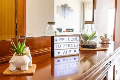 a counter with a welcome to peru sign and plants at Pérola Apartments by YOUR KEY in Caniço