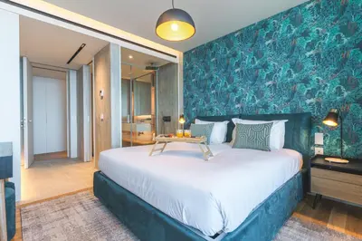 a bedroom with a large bed with a blue wall at Seaside Escape by Atlantic Holiday in Funchal