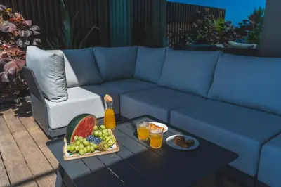 a blue couch with a tray of fruit on a table at Seaside Escape by Atlantic Holiday in Funchal