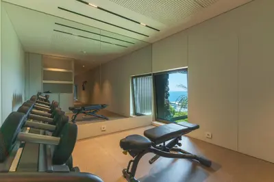 a gym with a row of chairs and a window at Seaside Escape by Atlantic Holiday in Funchal