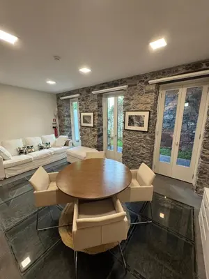 a living room with a wooden table and chairs at Atelier II by Real Vision in Funchal